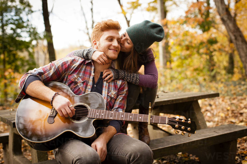 Romantic couple playing guitar in a healthy relationship